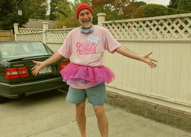 Angus Standing with arms wide in a pink Tshirt and tutu for CIBC Run for The Cure