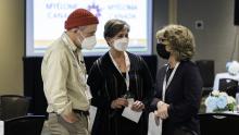 Angus with his red toque talking with pharma patient representatives.